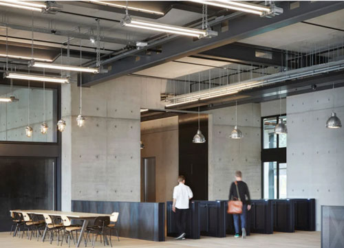 The Brunel Building opposite Paddington Station by Derwent London has an industrial aesthetic which lighting design practice EQ2 Light sought to complement with reclaimed lights sourced from Lightloom Design.