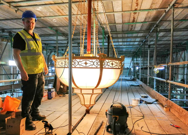 A Fritz Fryer restorer with a chandelier from the Grand Hotel Birmingham