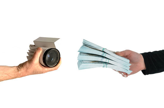 hands with cash and a hand with a light
