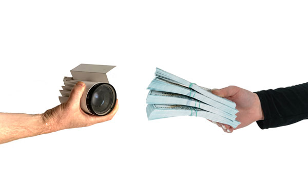 hands with cash and a hand with a light